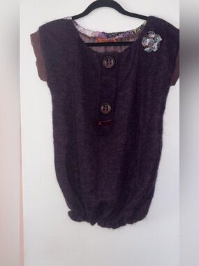 textured knit sweater vest features a unique combination of mixed materials